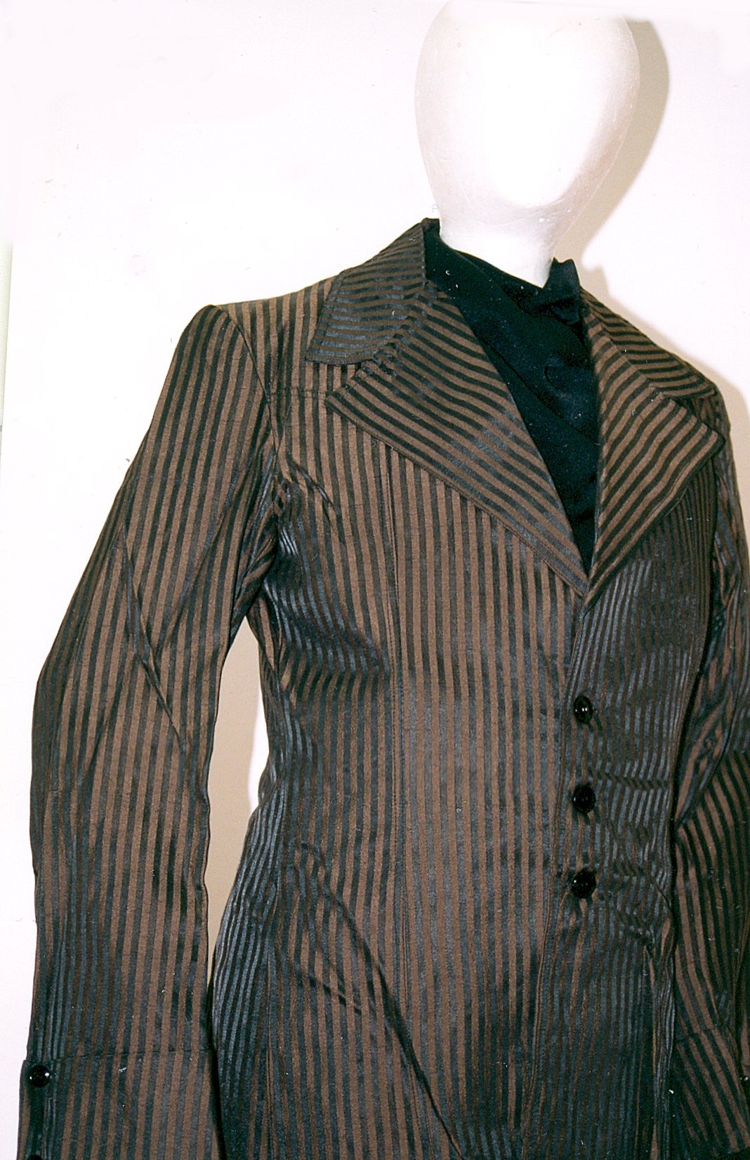 Black and tan stripe men’s single-breasted jacket  A black and tan stripe men’s single-breasted jacket epitomises the Teddy Boy look of British subculture in the 1950s where young men copied Edwardian-era fashion. Canterbury Museum 1984.70.15
