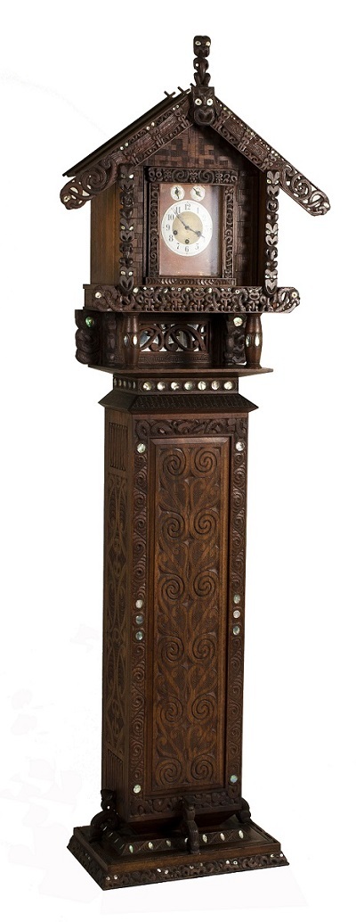 Long case clock, carved by J. H. Menzies, undated. The clock case exhibits all the exterior carved features of a pātaka or whare whakairo but reproduced in small scale. Private collection, photograph by author, 2015. All Rights Reserved