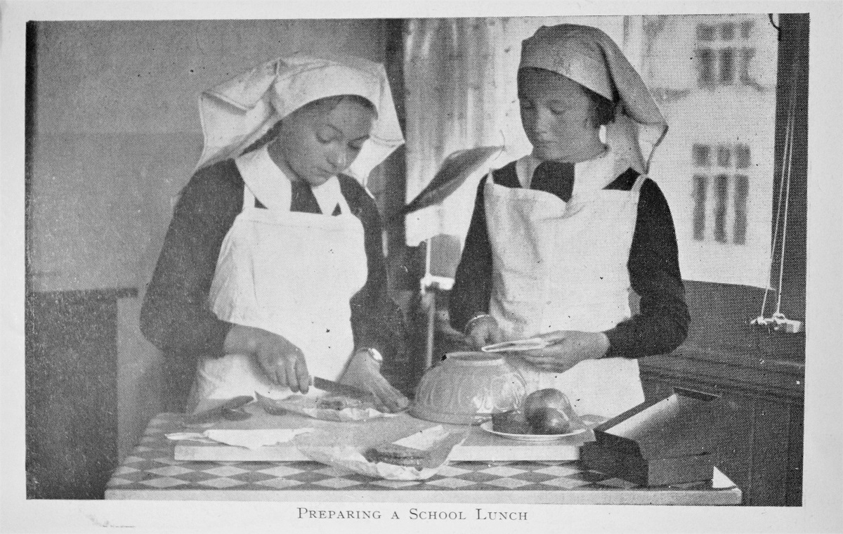 Young ladies preparing a school lunch in an illustration from Blackmore's book.