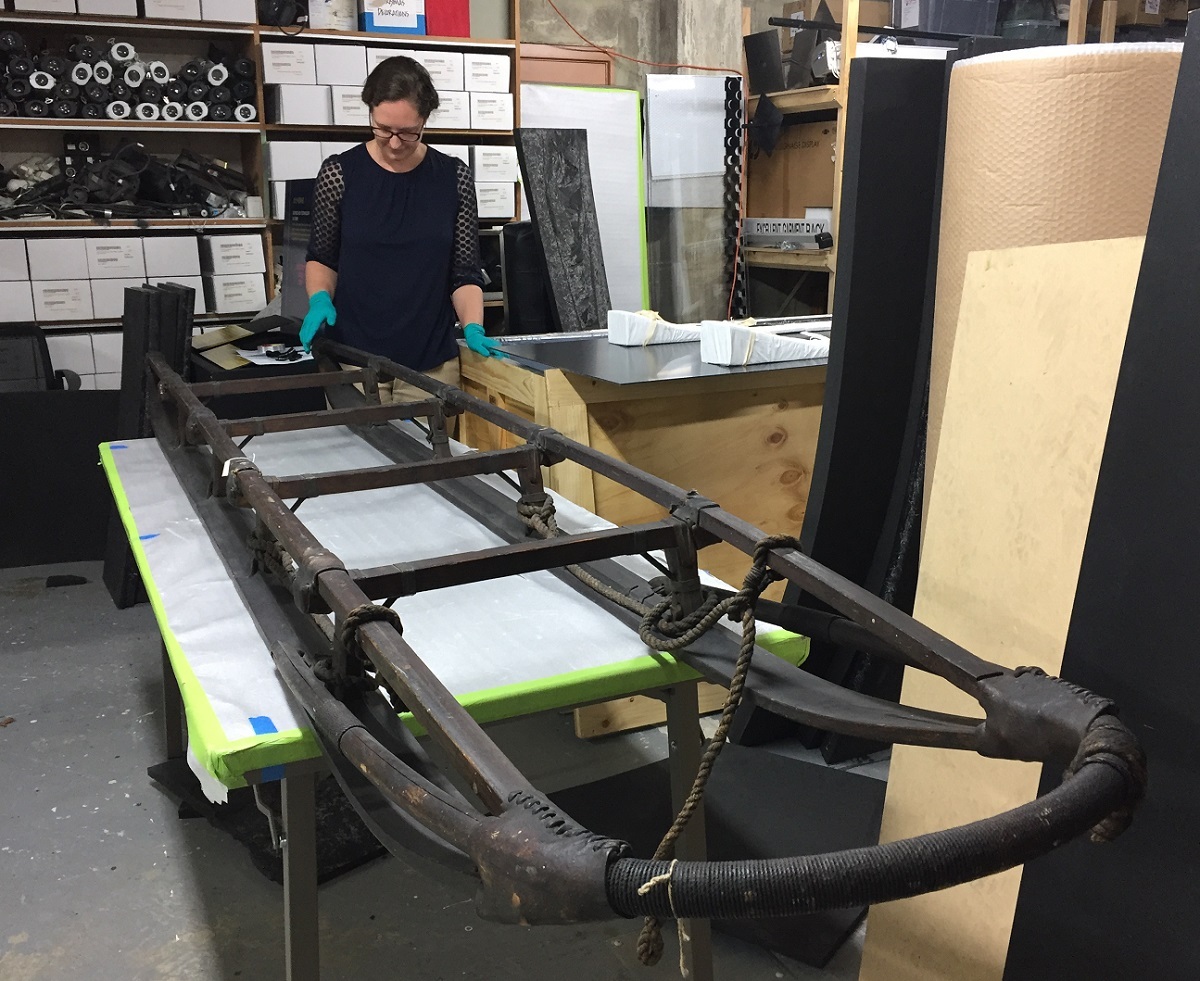 Conservator Emily Fryer prepares the sledge for packing for the journey to Chicago.