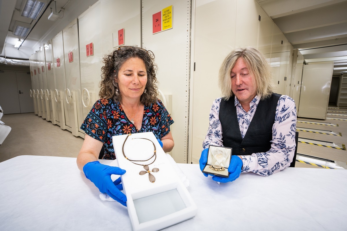 Julia Bradshaw, Senior Curator Human History and Lyndon Fraser, Research Fellow, with mourning jewellery from the collection including Emma Barker's brooch (right).