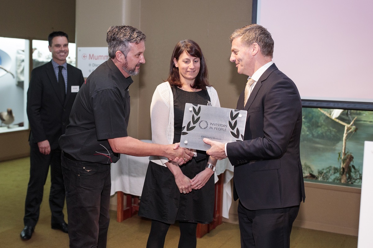 The Prime Minister The Rt Hon Bill English presents the award to Museum staff Paul Gallagher (second left) and Kristin Ramsdale, watched by Stuart Burgess, Investors in People NZ.