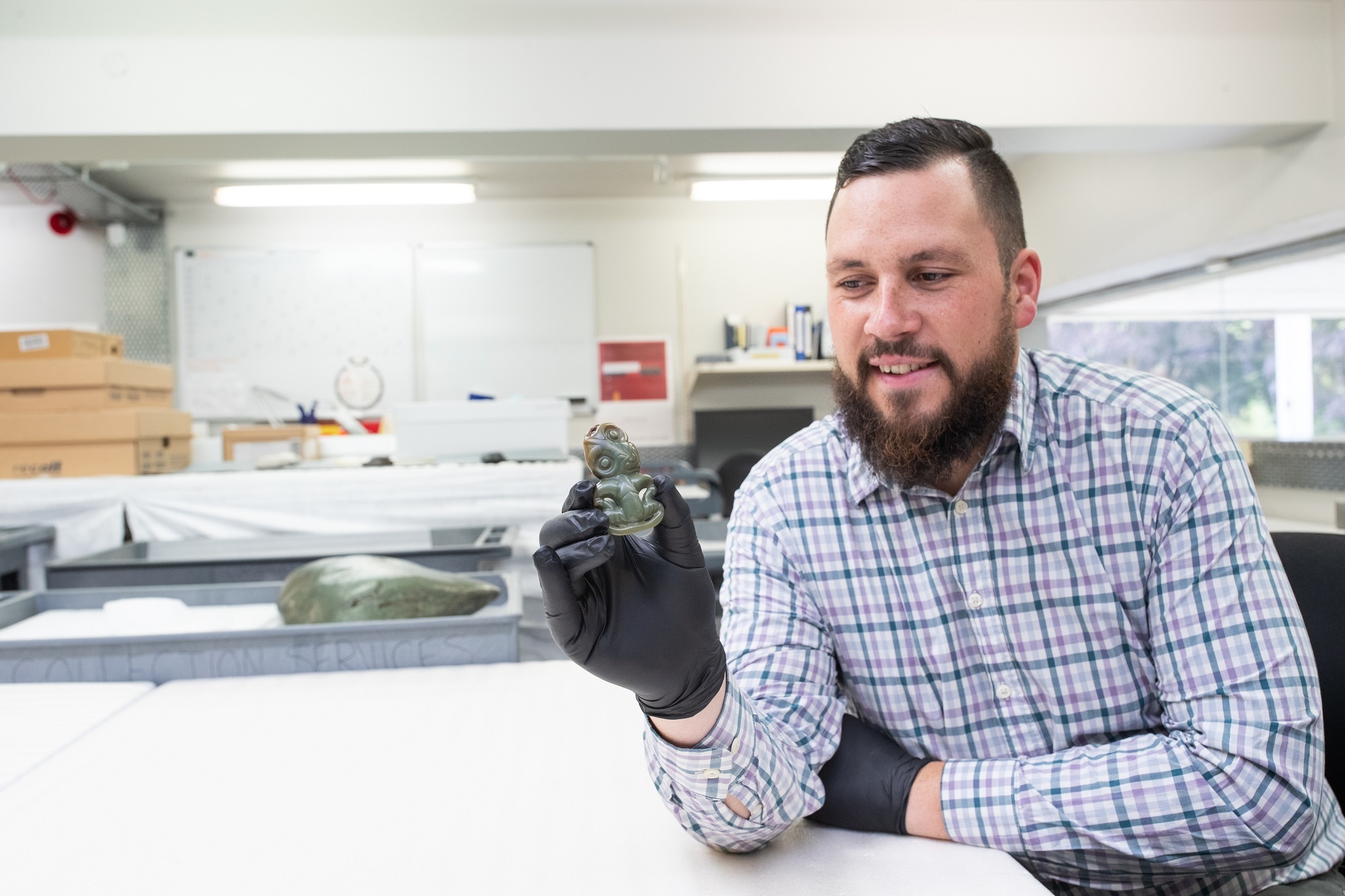 Corban Te Aika, Curator Human History (Mātauranga Māori) with the Te Aika hei tiki
