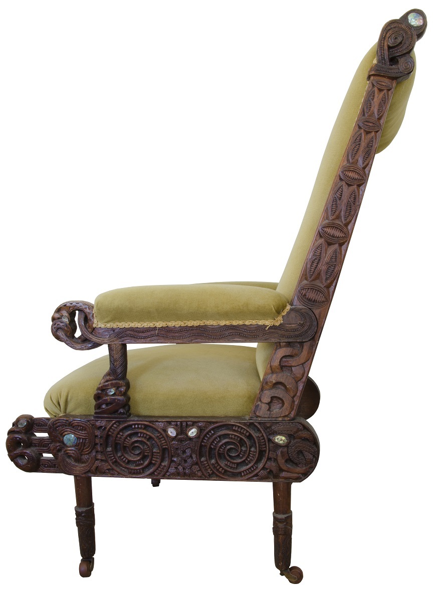 The seat frame on this armchair incorporates a reference to raparapa, the carved bargeboard ends on a meeting house porch. Private collection, photograph by author, 2016. All Rights Reserved